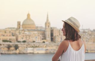 What is attracting international workers to Malta?